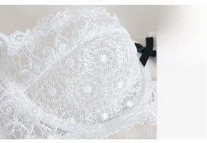 Macro shot of white floral water-soluble lace fabric with black satin bow detail