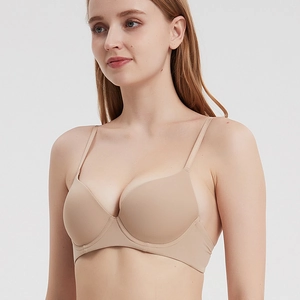 Seamless beige push-up bra for women with soft underwire and thin straps on a model