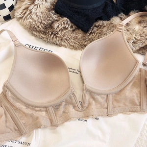 Close-up of nude lace bra featuring deep V-neckline and breathable mesh band