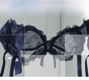 Detailed close-up of dark blue floral embroidery lace and scalloped edges on the bra cup