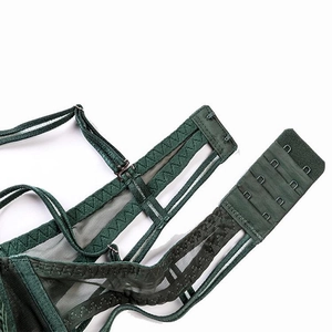 Detail of green lace bra showing four-row back closure and breathable mesh fabric