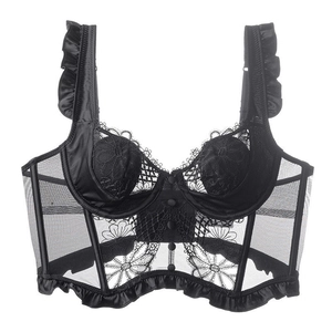 Detail of black lace corset top featuring floral embroidery and ruffle shoulder straps