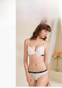 Detailed view of white push-up bra and panties set with elastic lettered trim