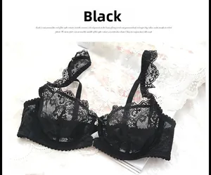 Detailed view of black eyelash lace bra with floral patterns and a metal charm pendant