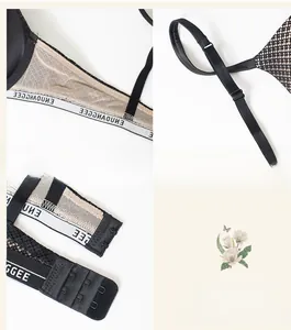 Detail of adjustable satin shoulder straps with ENJOYINGCEE lettering and mesh side wings