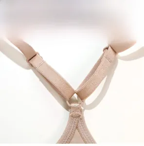 Detail of nude Y-shaped racerback straps on a French style lace bra with adjustable clips