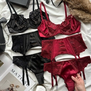 Three-piece French lace lingerie sets in red and black with satin details and garter belt
