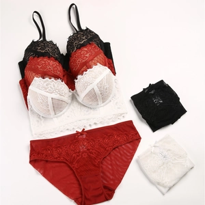 Detailed flat lay of French lace lingerie sets in red, black and white color options