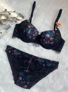Close-up of tropical floral print bra set with delicate black eyelash lace details
