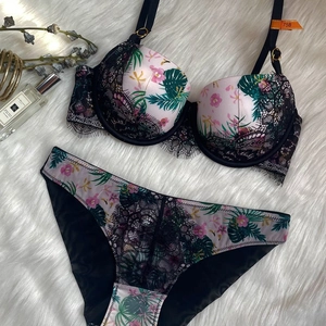 Flat lay detail of floral lace lingerie set featuring hibiscus print and 75B size tag