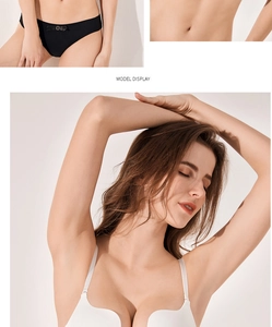 Detail of white seamless U-back bra with delicate bow and metal buckle on black panties