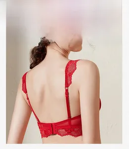Detail view of red lace bra featuring elegant flutter sleeves and sheer mesh back design