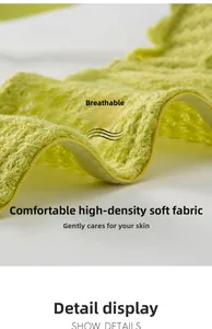 Close-up of soft breathable light green knit fabric with high-stitch craft details