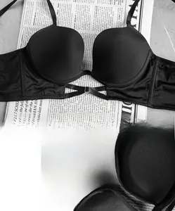 Detail view of black seamless W-cup bra featuring cross chest straps and soft underwire