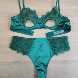 Detail of dark green satin lace lingerie set with eyelash trim and hollow design