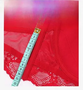 Close-up of 12cm wide red lace bra side wing showing supportive mesh fabric and measurement