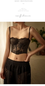 Detail view of black satin and lace corset lingerie set with intricate floral patterns