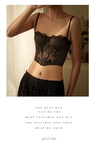 Detail of French style black lace satin corset top featuring delicate floral patterns