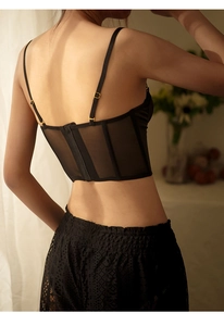 Detail of black lace corset with mesh fabric and fishbone support showing back view