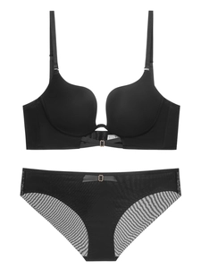 Macro detail of seamless deep V-neck bra and lace briefs with elegant metal buckles