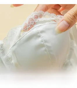 Close-up of white silk corset bra with delicate lace trim and breathable inner cup structure