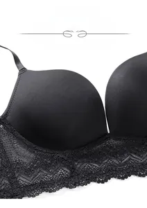 Close-up of seamless black bra with smooth cups and elegant floral lace detailing
