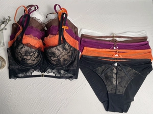 Flat lay of lace embroidery lingerie sets in various colors with 75B size labels