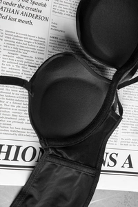 Detail view of seamless black push-up bra featuring breathable mesh wings and inner cups