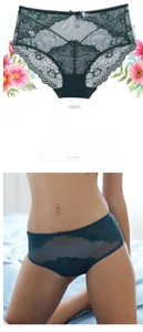 Detail view of dark green lace panties with mesh panels and a delicate bow decoration