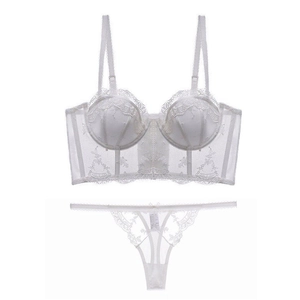 Close-up of white French embroidery lace bustier set with floral mesh patterns