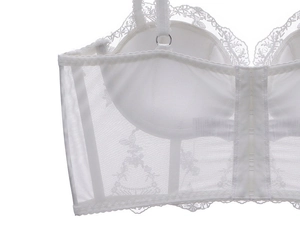 Detail of white French lace bustier with breathable mesh and multi-hook closure design