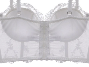 Close-up of white floral embroidery lace corset with mesh back and hook-eye closure