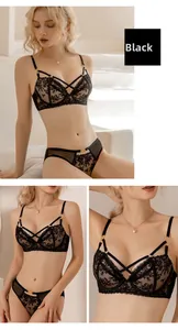 Detail of black lace lingerie set featuring gold rings and criss-cross strappy design
