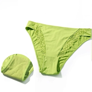 Close-up of apple green lace panties featuring delicate floral embroidery and fine stitching
