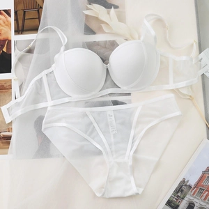 Ensemble lingerie en mesh blanc avec soutien-gorge push-up et culotte transparente sur fond