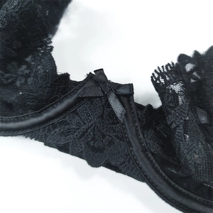 Close-up of black floral lace bra featuring a satin bow and delicate embroidery details
