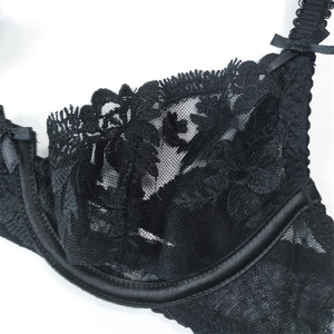 Close-up of black floral lace bra with semi-transparent mesh and delicate bow detail