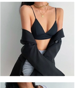 Detailed view of a black seamless triangle bralette paired with a chic blazer and jewelry