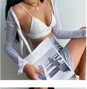 Close-up of white ribbed knit triangle bralette with matching long-sleeve cardigan top