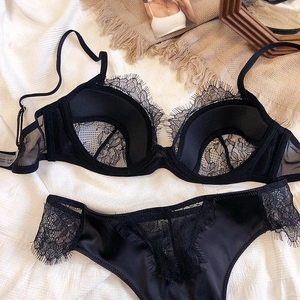 Detailed view of black eyelash lace lingerie set with contrast mesh and satin textures
