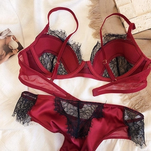 Detailed view of wine red satin lingerie set with black eyelash lace trim and sheer mesh