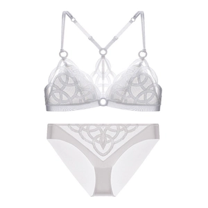 Detail of white mesh lace lingerie set featuring intricate geometric hollow patterns