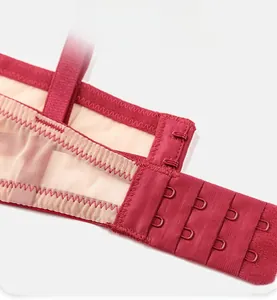 Detail view of red lingerie bra showing 4 rows 2 hooks back closure and breathable mesh