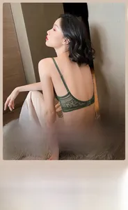 Detail of deep green French lace bra with large U-shaped back and slim adjustable straps