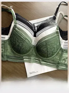 Detail of French lace bra sets with deep V-neck and U-shaped back design on wood