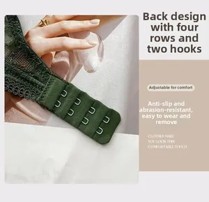 Detail of four-row two-hook back closure on dark green lace bra with fine mesh texture
