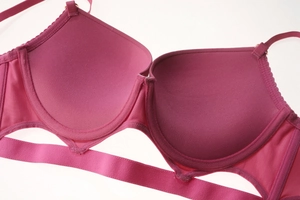 Detail of pink push-up bra featuring breathable mesh side wings and lace trim edges