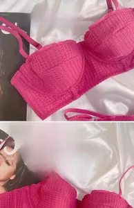 Detail of rose red lace bra showing 1/2 cup knitted texture and delicate floral lace edge