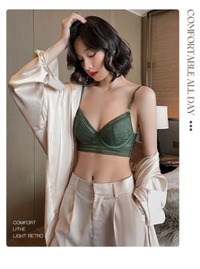 Detail view of emerald green lace bralette with delicate floral patterns and wide lace trim