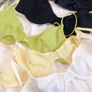 Flat lay of thin French style deep V bras in waffle texture black green yellow and white